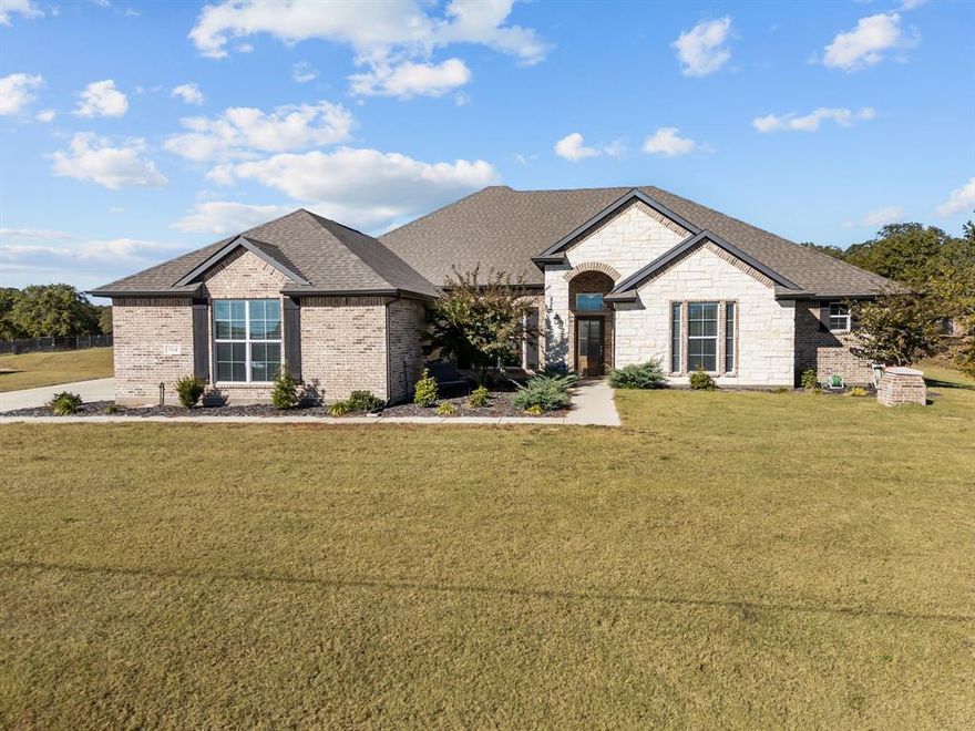 Located just off Zion Hill Road, this stunning semi-custom 4-bedroom, 3-bath home offers refined country living on just over 2 acres. Designed with premium finishes and an open, flowing layout, the home features expansive living spaces, abundant natural light, and an additional office that may serve as a guest room. Enjoy the convenience of three full baths, generous walk-in closets, and an oversized primary suite with a spa-inspired bath.

Step outside to a custom stamped and colored patio—perfect for evening relaxation or entertaining. The impressive insulated shop includes dual roll-up doors, RV pull-through parking, LED lighting, extensive electrical outlets, and an interior loft that can be finished for guest quarters or additional storage. The exterior features a full surround sound system to elevate outdoor gatherings.

This property has been thoughtfully landscaped for full usability and offers the freedom of no HOA, with horses and animals permitted. Additional upgrades include a water filtration system and security cameras. A rare combination of luxury, functionality, and wide-open Texas living—this home is truly a must-see.