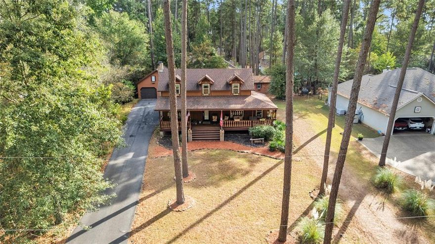 Forget the sterile suburban box. This is a masterclass in High-End Rustic. The heartbeat of this home is the soaring living area, where massive exposed timber beams draw the eye upward, anchored by a classic wood-burning stove that promises cozy East Texas winters. The cedar-sided exterior blends seamlessly into the wooded cul-de-sac, offering a sanctuary that feels miles away from everything, yet sits safely within the prestigious Holly Lake Ranch gates. With the primary suite on the main floor, this layout is designed for effortless, single-level living while the upstairs loft provides the perfect perch for guests or creative focus. This isn't just a house; it’s a deep breath in architectural form.