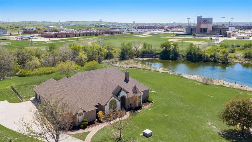 Rare opportunity to own a home in one of the most desirable locations in Aledo! This 4 bedroom, 3 bath, with study sits in the shadows of Bearcat Stadium in the gated community of Shadow Creek Ranch. Not only does this 1.41 acre lot sit in a cul-de-sac, it backs up to a private pond, has a swimming pool and has a bridged walkway connecting to Coder Elementary and Aledo High School. Recently updated hand scraped hardwoods in the living room, study, dining and kitchen. JBL surround sound speakers in living area. The elegant kitchen features a double oven, electric cooktop, eat at bar and plenty of counter and cabinet space. Sizeable primary bedroom with seating area overlooking the pool and pond. Enjoy nights on the covered back patio with a wood burning fireplace, sink and room for a refrigerator. Secondary bedrooms with Jack and Jill bathroom and the guest room with additional bathroom with shower. Three car garage, with stairs for attic access. Minutes from IH-20 and local shopping.