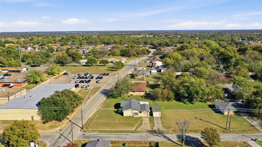 Charming Brick Home in the Heart of Springtown!  Situated on a roomy corner lot within the downtown Springtown area, walking distance to the square.  This two-bedroom home blends comfort, character, and convenience. Inside, you’ll find a spacious kitchen with updated counter tops, a separate laundry room with extra storage. 

A covered breezeway connects the home to the detached one-car garage, which also includes an additional 9x10 storage or workshop area. Need even more space? You’ll love the 30x12 metal workshop complete with electricity, a slab foundation, garage door access, and an extra 8x12 room with built-in shelving.

The fenced backyard with room to enjoy the outdoors on the covered patio. Property spans approximately 1.5 city lots, giving you the space and flexibility. 
Buyer and buyers agent to verify all information including use of extra space on additional lot area.