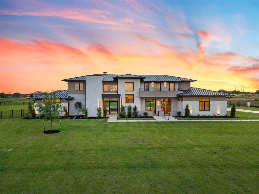 Positioned to sell — bring your clients’ best proposals. Set on two private, fully landscaped acres, this exceptional Bartonville estate blends quiet luxury, architectural craftsmanship, and modern convenience. Offering 10,420 SF under roof (6,977 SF air-conditioned) with five garage bays, the home provides rare privacy while remaining close to all that Bartonville offers, including highly rated Argyle ISD and proximity to Liberty Christian School.
A striking iron-and-glass entry, Class 4 standing seam metal roof, and expansive Andersen and Western windows create a timeless exterior and light-filled interiors. The backyard is a true retreat with a resort-style pool and spa, water features, concrete pavers, mature trees, full irrigation, and black iron fencing.
Two covered outdoor living areas are designed for year-round enjoyment—one with a gas fireplace, heaters, and TV, and the other a fully equipped outdoor kitchen with premium appliances and Phantom screens.
Inside, refined finishes include 5” white oak hardwoods, honed stone columns, Level 5 smooth drywall, 8’ solid-core doors, custom cabinetry, quartzite and quartz countertops, and layered LED lighting. The private primary suite features a coffee bar, dual custom closets, and a spa-level bath. Four additional en-suite bedrooms, a family room with gas fireplace, dining space, leisure-wine room, game and theater room, office, and gym complete the thoughtful layout. A smoked-glass residential elevator offers seamless access. 
The home is enhanced by Sub-Zero-Wolf appliances, Control4 automation, Lutron lighting, whole-home audio, advanced security, foam encapsulation, multistage HVAC, and tankless water heaters—delivering understated luxury, comfort, and effortless living in one of Bartonville’s most coveted settings.  Guest suite is large enough to be second primary and elevator to second floor.