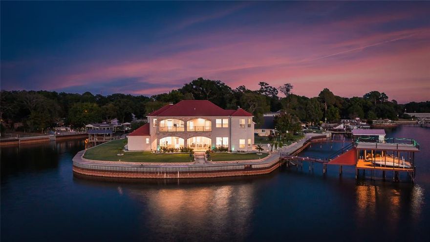 Imagine owning a breathtaking waterfront property on an open water peninsula with 363 feet of  shoreline— This incredible 4-bedroom home (plus office, which could also serve as a formal dining room or 5th bedroom) offers a lifestyle of luxury and relaxation, directly on the water at Cedar Creek Lake. Designed to take full advantage of the expansive views, the home features almost every room with stunning water vistas. You'll love the spacious, open floor plan with real wood floors, soaring 12-foot ceilings, and large windows that invite natural light and panoramic views throughout. The kitchen includes a large island with seating, granite countertops, and a wine refrigerator, perfect for entertaining or enjoying family meals. The main floor water side master suite offers a serene retreat with a gorgeous bathroom featuring double vanities, a separate tub, a walk-in shower with multiple heads, and a custom walk-in closet. Additional highlights include a bonus room for a second living area or game room, a media room or bunk room, and an oversized 3-car garage. Step outside to enjoy the screened porch with an outdoor kitchen with sink and oven or relax on the composite decked boathouse, which includes a party deck and covered sitting area, perfect for lakeside entertaining. Onduvilla roof, a waterproof clay tile look roof designed and guaranteed to withstand winds up to 150 miles per hour per the manufacturer.  in Gun Barrel City on Cedar Creek Lake, this home is just an hour from downtown Dallas, yet a world away from the hustle and bustle. With all the furniture, boat, and personal watercraft included, this home is truly a turnkey waterfront retreat!