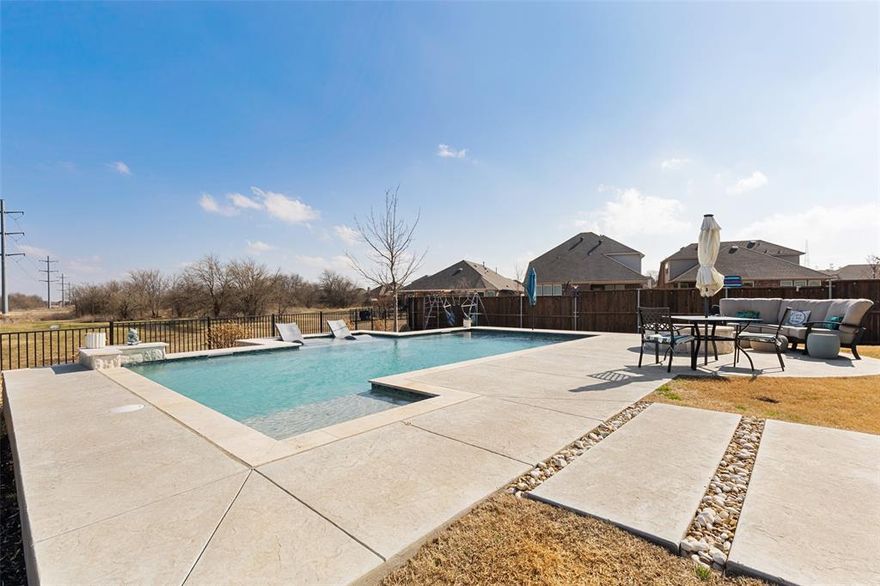 Are you looking for a place to enjoy the summer days lounging by a pool? Here is the place for you! Stunning backyard pool, firepit, and built-in prep area with drink cooler. Private and secluded, backing to a greenbelt and pond. Close to dining, entertainment, shopping, and schools. This 1-level 3 BDRM, 2 bth home is just as impressive as the outside: wood-grain tile floors, neutral paint colors, crown molding, and an open floor plan. The chef's kitchen features granite countertops, stainless steel appliances, white cabinets, gas cooktop, designer vent hood, spacious island with breakfast bar, tile backsplash, and a pantry—office area with built-in desk and cabinets off kitchen. Primary bedroom suite offers luxurious walk-in glass and tile shower, dual sinks and vanities, and 2 walk-in closets, making mornings effortless. Oversized study features built-in TV spaces, perfect for gaming. 2 add'l bdrms and bth. Garage has epoxy floors and built-in storage.