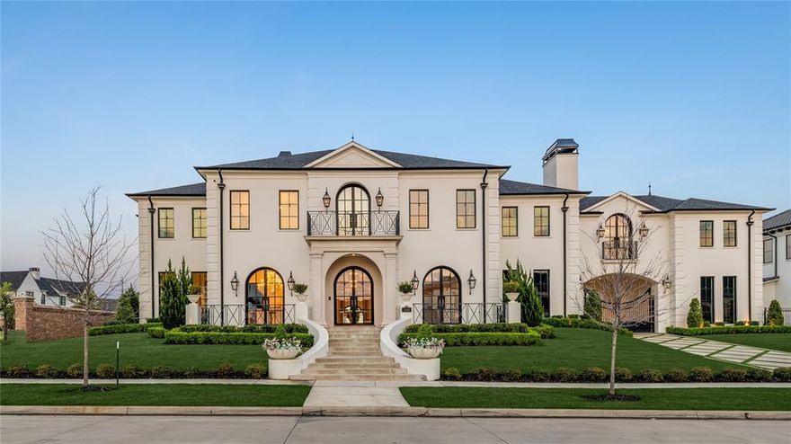 Stunning luxury custom home by award-winning builder, Coats Homes, constructed of architectural brick with slurry mortar, on an elevated corner lot in Newman Village’s exclusive Homestead. Timeless Jerry Coleman design blending French neoclassical with modern contours. Highlights include a boutique closet suite, 18' steel windows, a floating spiral staircase, and a plaster-groined gallery leading to a lofty family room wrapped in steel and anchored by a double-sided limestone fireplace shared with the showpiece kitchen. Chef’s kitchen pairs a Wolf range with griddle, dual dishwashers, paneled fridge and freezer, extra-tall counters, and a scullery; a lacquered galley bar with ice maker and wine fridge elevates entertaining. Refined office with fireplace and Sonance invisible audio, mudroom with lockers and electric dog door, and mirrored gym all open to the courtyard. Main-level primary suite offers coved-ceiling bedroom, fireplace, and arched doors to the pool. Spa bath with shower, freestanding tub, dual vanity, towel-warming drawer, and pool access. Boutique closets: her fashion salon (triple mirror, jewelry island, shoe walls, rolling ladder) and his tailored walk-in. Upstairs: three ensuite bedrooms with walk-ins, a queen-bunk suite, laundry, a theater-ready flex room with rock wall and monkey bars, and a library or optional bedroom. Multi-slides open to a covered loggia (Wolf grill, beverage center, fireplace, TV, built-in audio) overlooking a turfed yard and pool with tanning ledge, bubblers, heater, and child-safety fence. Key highlights: gated porte cochere; 4-car garage with lift for 5-6 (holds 6); Unifi 4K security; Lutron lighting; advanced HVAC (iComfort, humidification, air-scrubbing); level-5 walls; utilities for future gazebo and generator pad; fortress foundation on helical piers. Architectural masonry with cast-stone accents, steep slate-profile roof, wrought-iron finials, ten gas lanterns, and tailored landscaping deliver enduring French presence.