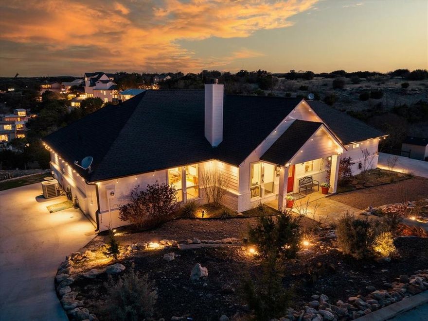 Tucked into a quiet, protected cove at the approach to Hell’s Gate, this nearly one-acre Gaines Bend property offers expansive water views, calm no-wake water, and one of the most recognizable locations on Possum Kingdom Lake.  The 3-bedroom, 3-bath home is positioned to capture sweeping sunset views while enjoying the privacy of a protected cove just outside the activity of Hell’s Gate.  From its elevated setting, you can watch fireworks light up the sky overhead — close enough to enjoy the show, yet removed from the congestion and heavy boat traffic.  Designed for gathering and easy lake living, the home opens to layered composite decks that create multiple outdoor living zones. A covered patio with fireplace, grilling station, and open-air lounge areas overlook the water, while a lakeside tiki retreat provides a tucked-away perch near the shoreline. Inside, the layout is comfortable and functional, offering flexibility for weekend guests or full-time lake living.  A stone retaining wall and stairway lead to a private dock with boat lift in approximately 12 feet of water at full pool.  The nearly one-acre setting provides uncommon elbow room in Gaines Bend — space for lake toys, gatherings, and future personalization.  Whether envisioned as a weekend escape or full-time lake residence, this property offers the rare balance of protected water, iconic proximity, and room to make it your own.