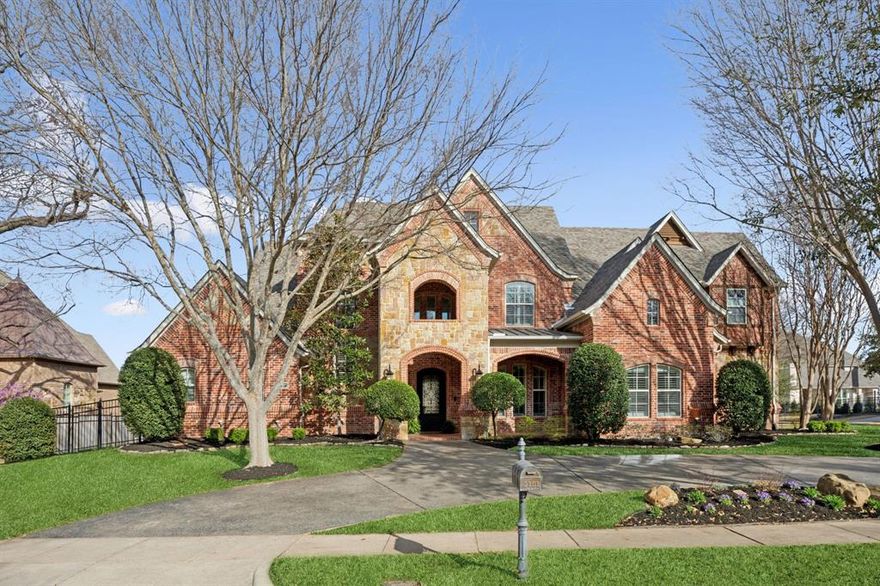 Nestled on an oversized 0.518 acre corner lot, surrounded by mature trees and lush landscaping. A grand entryway leads into an open-concept design, where soaring ceilings, a dramatic wall of windows, and rich herringbone hardwood floors create a sense of warmth and sophistication. The gourmet kitchen is a chef’s delight, featuring commercial-grade appliances, granite countertops, a butler’s pantry, and a wine cellar. A stylish study with built-ins provides a functional workspace. The primary suite offers a serene retreat with a spa-inspired bath, while a private guest suite completes the main level. Dual staircases lead upstairs to three spacious ensuite bedrooms, a game room with a wet bar, and a media room. Designed for both  entertaining and intimate gatherings, the private backyard is a true sanctuary, boasting an expansive outdoor kitchen and living area, a sparkling pool, and a spa, all surrounded by lush landscaping. This impeccably maintained estate offers an unparalleled lifestyle of charm, sophistication, and comfort. Enjoy the best of Southlake with it's fantastic dining, shopping, and entertainment. Located in the award winning Carroll ISD!