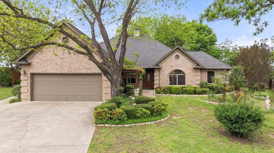 Nestled in a serene cul-de-sac within a picturesque golf course community south of Fort Worth, this charming three-bedroom, two-bathroom home is a perfect blend of comfort and elegance. The open concept design seamlessly connects the living, dining, and kitchen areas, creating a spacious atmosphere ideal for both entertaining and everyday living. Kitchen is equipped with Double Oven, Refrigerator, Dish Washer, Advantium Fast Cook Microwave-Oven and ample cabinetry, providing both functionality and style. Large primary bedroom boasts an ensuite bathroom with a soaking tub and a separate shower. Two additional bedrooms are generously sized, making them perfect for family, guests, or a home office. Gardeners will appreciate large lot and  heavily landscaped yard that offers a peaceful retreat with mature trees, colorful flower beds, and a spacious patio areas, ideal for outdoor entertaining or simply enjoying the tranquility of the surroundings. Community Amenities include use of 2 golf courses, Marina, Fishing, Tennis, Pickle Ball, Volley Ball, Fitness Center, Restaurants, RV Overnight Parking Rental and community events, enhancing the lifestyle experience. This home not only provides a comfortable living environment but also an inviting atmosphere in a vibrant community, making it the perfect spot for families or anyone seeking a blend of relaxation and recreation.