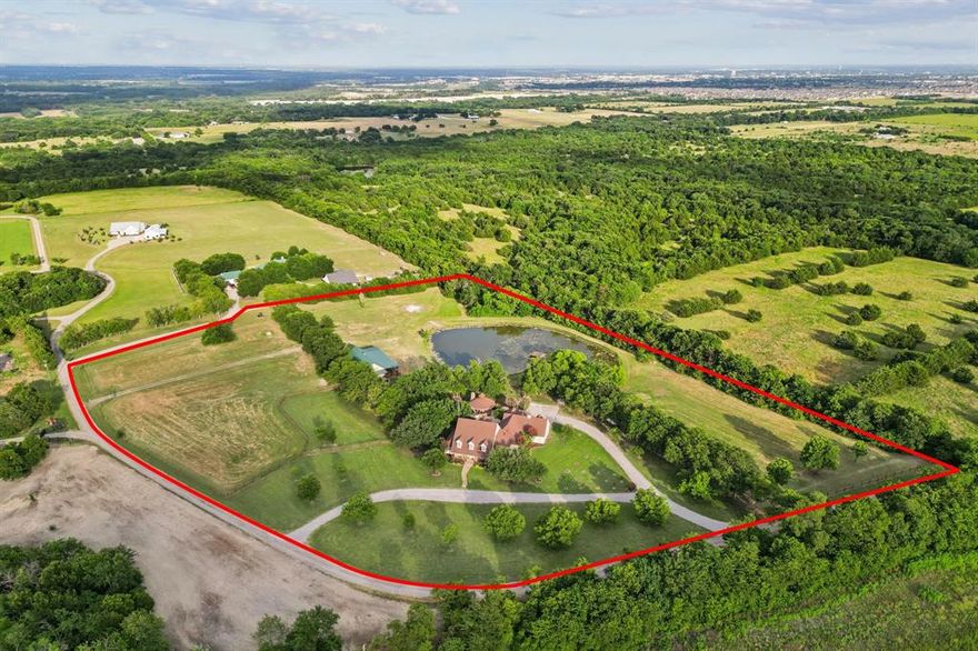 Rare opportunity to own a private 10-acre luxury family compound in the heart of McKinney with NO City Taxes and current ag exemption. Designed for multi-generational living and resort-style entertaining, this exceptional property features a 5,344 sq ft main residence, separate 1,933 sq ft guest house, private pond, horse-ready acreage, and stunning outdoor living spaces just minutes from McKinney conveniences. The main home offers 6 bedrooms, 4.5 baths, executive study, formal dining, expansive living room with stone fireplace and built-ins, and a gourmet kitchen with granite countertops, center island, gas cooktop, double ovens, stainless steel appliances, walk-in pantry, and large breakfast area. Downstairs primary suite features bay window sitting area, dual walk-in closets, soaking tub, separate shower, and dual vanities. Upstairs includes a game room with built-in bar and beverage fridge, bonus space, four additional bedrooms, and two full baths. Attached 4-car garage. The separate guest house is ideal for extended family, guests, private office, or retreat-style living with open-concept living area, kitchen with granite countertops and stainless appliances, downstairs primary suite, upstairs game room, two additional bedrooms, two full baths, and large attached storage or garage area.
Resort-style outdoor living includes a pool with waterfall, diving board, spa, expansive covered pavilion with bar, grilling station, fireplace, beverage fridge, multiple patios, fire pit, mature trees, fenced horse area, and peaceful private pond. Beyond the main living areas, the property offers fenced horse-ready acreage, a private pond, mature trees, open green space, and the privacy of a true Texas retreat while remaining conveniently close to shopping, dining, and major commuting routes. A rare blend of luxury, privacy, flexibility, and Texas lifestyle living.