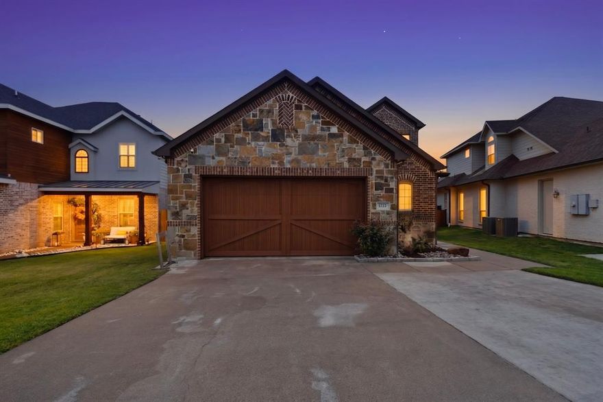 Imagine waking up to the sun dancing across Lake Ray Hubbard, where every room feels like a front-row seat to nature's masterpiece. This 3,000+ square foot sanctuary offers a seamless, open-concept flow designed for those who value both elegance and ease. At the heart of the home, a chef’s kitchen awaits, anchored by an expansive oversized island. With double ovens and a deep farm sink, it’s a space where holiday feasts and casual breakfasts feel equally special, all while panoramic lake views serve as your constant backdrop. The primary suite is a true retreat, offering serene water vistas and a spa-inspired bath. Yet, its most remarkable feature is a safe room of legendary proportions. Constructed of concrete and rebar-reinforced cinderblocks with a reinforced ceiling and secured by dual quarter-inch steel plate doors, this is a fortress. When a devastating storm swept through in 2016, this structure stood as the sole survivor on the lot—a testament to the uncompromising safety it provides. With access from both the interior and the backyard, it offers priceless peace of mind. Versatility defines the floor plan, featuring a downstairs secondary bedroom with an ensuite bath, perfect for guests or multi-generational living. Upstairs, a massive game room with a stone fireplace provides a cozy escape, leading to a covered balcony ideal for sunset dining or morning coffee overlooking the water. The lifestyle extends outdoors to a private oasis featuring a deck, hot tub, and a sprawling lawn rolling down to the water’s edge. Protected by a reinforced seawall, your shoreline includes a covered boat lift for easy access to world-class fishing and boating. Beyond your gates, the community offers tennis and pickleball, while nearby Paddle Point Park and Lakeside Park South provide kayaking, volleyball, and miles of hiking trails. This is more than a home; it is a legacy of strength and beauty on the water.