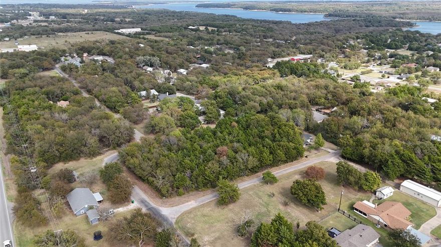 Rare opportunity to own three adjoining, buildable lot s in the desirable Simmons Shores community at Lake Texoma! Lot s are flat, cleared, and ready for construction, making this the perfect location for a lake house, barndominium, short -term rental, or forever home. Enjoy amenities including a boat dock, swimming pool, playground, and picnic area, offering year-round relaxation. Located within Pottsboro ISD, and just minutes from Highport Marina, Tanglewood Resort, and the open waters of Lake Texoma, this property combines the best of small-town tranquility and lakeside living. Whether you’re looking to build now or hold as an investment, this property offers excellent value. GPS (33.8199337, -96.6806725)