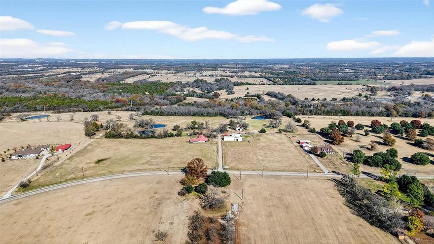 Discover the perfect blend of country comfort and multi-generational flexibility on this beautiful 28-acre property located along FM 697 in Sherman, Texas. The main home, built in 1965, features a 3-bedroom, 2-bath layout with a desirable split-bedroom floorplan, offering privacy for the primary suite and an efficient flow throughout approximately 1,862 sq ft of living space. Large living space and wide-open views create a warm and inviting atmosphere ideal for everyday living. In addition to the primary residence, the property features two attached one-bedroom in-law suites, each with its own private entrance. These suites are ideal for extended family, guests, or potential rental income, providing exceptional versatility rarely found in properties of this size. Outdoors, the land is fully fenced and showcases three ponds, ideal for livestock, horses, or recreational enjoyment. A spacious 30x50 shop adds exceptional utility for equipment storage, vehicles, hobbies, or a home-based business. With open pasture, mature trees, and scenic water features, this acreage offers the freedom to create the lifestyle you’ve been dreaming of. Enjoy unmatched privacy with convenient access to Sherman, while still being close to major highways, shopping, and schools. Whether you're seeking a homestead, multi-family living arrangement, or a functional agricultural property, this unique estate offers it all.
