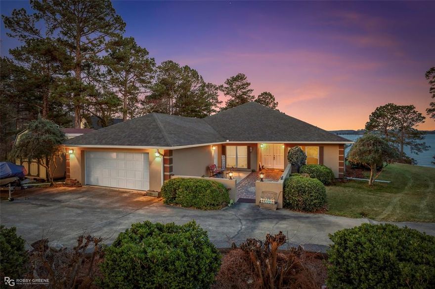 It’s all about the VIEW!! Located on the peaceful shores of Lake Claiborne, this 3-bedroom, 2-bath home offers comfortable living, thoughtful construction, and incredible waterfront scenery that makes lake life truly special. Step inside to a spacious living room featuring high ceilings and an open, airy feel, with large windows and glass doors that draw your eyes straight to the water. The home was built with reinforced construction and anchored structural corners! Throughout the home, every window features elegant marble window sills, adding a custom touch and timeless detail. The lakeside lanai spans the entire back of the home and is one of the standout features of the property. With three sets of glass doors opening from the living spaces, this inviting area provides the perfect transition between indoor comfort and outdoor beauty.  The patio furniture on the lanai will remain with the home, making it ready for immediate enjoyment. The kitchen offers abundant cabinetry, generous counter space, and appliances that are less than five years old making meal prep & entertaining phenomenal. The remote primary suite provides privacy and comfort, featuring lake views, double closets, and a spacious ensuite bath, with a soaking tub and a beautifully updated custom walk-in shower. Two additional bedrooms offer comfortable accommodations for family or guests, while the guest bathroom also features a custom walk-in tiled shower. Just steps from the backyard, the large covered boathouse features two boat stalls, a generous sitting area and firepit at the waters edge! Swim from the pier, enjoy fishing right off the dock, or head out for a day of boating and watersports. A full house generator & full yard sprinkler complete the outside. Whether you are looking for a full-time lake residence, a peaceful retirement home, or a weekend getaway, this property offers the perfect combination of comfort, quality construction, and unforgettable waterfront views.