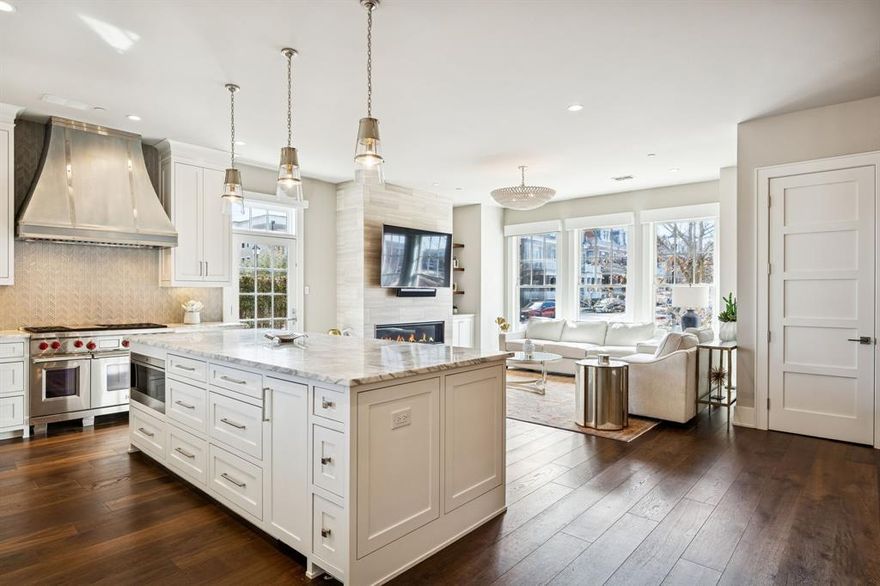 Welcome home to refined luxury living in the heart of Southlake Town Square—where upscale convenience meets effortless lock-and-leave ease. Just steps from premier restaurants, boutique shopping, vibrant community events, and everyday essentials, this exceptional four-story residence offers an unmatched walkable lifestyle. The main floor is the true centerpiece—designed to impress while remaining warm and livable. Flooded with natural light, the elegant living room flows seamlessly into the gourmet kitchen, creating an ideal setting for entertaining and everyday living. The chef’s kitchen is beautifully appointed with premium Wolf and Sub-Zero appliances, including a built-in ice maker, marble countertops, custom cabinetry, and high-end fixtures. A designated study offers a quiet, refined work-from-home space, while a secondary primary suite with an ensuite bath provides comfort and flexibility for guests or multigenerational living. Completing this remarkable level is a covered rooftop patio with a built-in grill and private dog run—an exceptional outdoor retreat that expands the living space and perfectly complements the vibrant surroundings. Serviced by a private elevator, the upper levels continue the home’s thoughtful design. The second floor features a stunning primary suite with a sitting area and beautiful views, along with a spa-inspired bath boasting a standalone tub, rain shower, dual vanities, and a custom walk-in closet. Two additional bedrooms, each with ensuite baths, complete this level. The third floor adds versatility with a large bonus room with wet bar, an additional bedroom, and full bath—ideal for guests or extended stays. The ground level offers an oversized three-car garage with electric vehicle charger and a spacious bonus room with half bath, perfect for a home gym, recording studio, workshop, or additional living space tailored to your needs. Schedule a private showing today to discover why this residence is truly extraordinary.