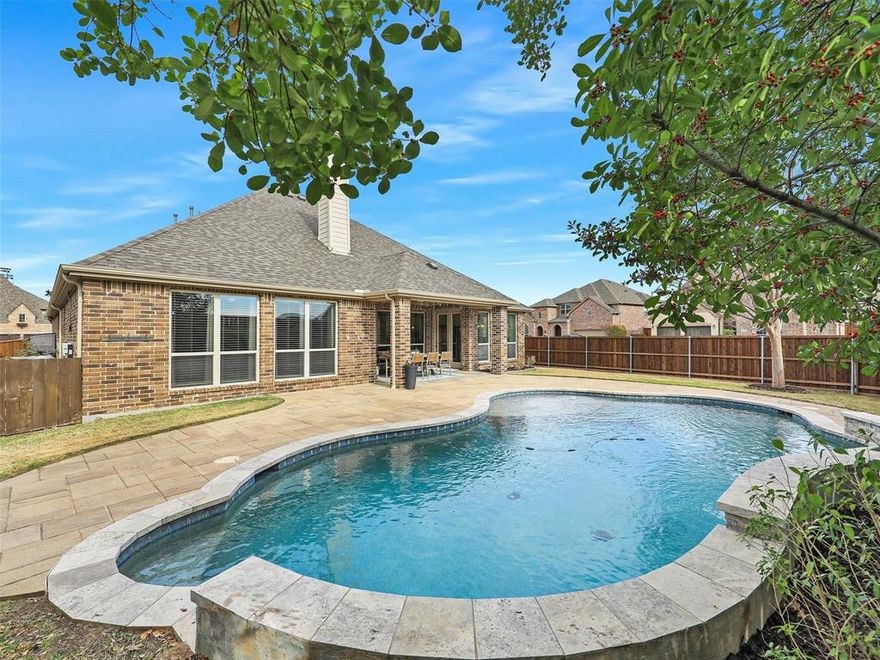 This impeccably maintained, single-story American Legend home offers modern conveniences and is located within the highly acclaimed Prosper ISD. Just off the entry is a private office, and a hallway leads to two separate bedrooms—each with spacious walk-in closets and ceiling fans— both of which share a full bathroom. Guests have access to a convenient half-bath down the main entryway.

At the heart of the home is an oversized dining area that easily fits large family gatherings. The open floor plan centers around a family room with hardwood floors, a stone-accented gas-log fireplace, and pre-wired surround sound. The island kitchen features quartz countertops, stainless steel appliances, a walk-in pantry, breakfast bar, convection oven, microwave, gas cooktop, and ample cabinet and counter space. A bright breakfast nook overlooks the generous backyard, which includes a covered patio and a stunning play pool with a waterfall.

The expansive primary suite also overlooks the pool and provides a sitting area, ensuite bath with dual vanities topped with quartz, a garden tub, separate shower, and a spacious walk-in closet. The utility room accommodates a full-size washer and dryer, plus space for a second refrigerator or freezer. Beyond the utility and mud area is a three-car tandem garage with epoxy flooring and a 220V outlet, ready for EV charging.
Additional highlights are the Govee permanent outdoor lighting system, a newly installed six-foot cedar privacy fence (2024), a new roof (2024) and eight-foot solid core doors.

Nestled in a quiet, established neighborhood, this home is just a block from Frontier Park—a hub for community events like Fourth of July fireworks, youth baseball, soccer & football events, fishing tournaments, and holiday celebrations. It's conveniently located just over a mile from the Dallas North Tollway (under construction), offering easy access to Frisco, Plano, and Dallas. There are no MUD or PID fees!