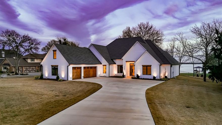 Experience luxury lakeside living in this stunning 4-bedroom, 4-bath home on Richland Chambers Lake, nestled in the prestigious Shores subdivision. Designed for both comfort and elegance, this home boasts breathtaking lake views through large windows that flood the space with natural light. The open-concept living area features a cozy fireplace, perfect for relaxing evenings. A chef’s dream, the spacious kitchen includes a large island, floor-to-ceiling cabinets, a high-end Wolf gas cooktop, and a butler’s pantry with a sink for added convenience. Electric shades adorn every room except the living room, offering effortless privacy and light control. The primary suite is a true retreat, complete with an ensuite bath featuring a freestanding soaking tub, a separate shower, and a custom walk-in closet with direct access to the laundry room. A second bedroom also boasts an ensuite bath, while the versatile third bedroom includes a Murphy bed, making it ideal as a guest room or office. Entertainment is effortless in the expansive game room, equipped with a wet bar and refrigerator. Upstairs, a private bedroom with a sitting area and full bath provides a secluded getaway for guests. Step outside to enjoy the beautifully landscaped backyard, enclosed by an iron fence, leading to your own boathouse—perfect for enjoying the best of lakefront living. With its prime location, thoughtful design, and upscale finishes, this exquisite home offers the ultimate blend of luxury and relaxation. Don’t miss this rare opportunity to own a piece of paradise!