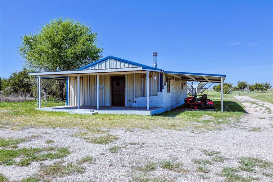 2 bedroom, 1 bath barndominium featuring a cozy wood burning fireplace, excellent insulation, and a comfortable eat in kitchen. There is also a versatile bonus room that can be used as an office, podcast space, nursery, or flex room to suit your needs. The property has been well maintained, with all 9 acres thoughtfully cleared and cared for. Enjoy a charming picnic area surrounded by blueberry, apple, pear, and raspberry trees. Additional features include a wood log shed fully stocked with oak, a 1300 gallon water storage shed, and a fenced area with a water trough for animals. Solar panels, owned by the sellers, can be included or excluded based on buyer preference. The seller services the water well and septic system at least once per year, ensuring consistent performance and quality. Come experience affordable country living with everything you need, and nothing you don’t.