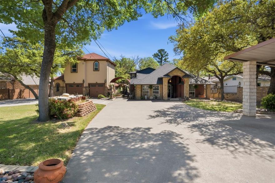 Rare Lakefront Estate! Dual Homes on Lake Weatherford! Ultimate Entertainer’s Paradise! This exceptional waterfront estate features two homes on adjoining lots with unmatched amenities, offering the perfect blend of luxury living and resort-style entertaining. The impressive 4,470 sq ft main residence showcases 4 bedrooms and 3.5 bathrooms, designed for both comfort and entertaining on a grand scale. Expansive living spaces include a large Living Game room with stone fireplace, a heated and cooled outdoor kitchen and sunroom that serves as a 2nd living area filled with natural light. The chef’s kitchen is a standout, equipped with a Viking gas cooktop and double oven, dual sinks, two dishwashers, icemaker, oversized island, commercial-grade vent hood, and walk-in pantry. The private study offers custom wood built-ins. Two luxurious primary suites provide flexible living options—both with sitting areas and ensuite baths. Upstairs suite features a separate jetted tub and shower, while downstairs suite includes a spacious walk-in shower and linen storage. Step outside to your private resort: a sparkling in-ground pool & spa, cabana, expansive outdoor living spaces, and private docks with covered boat lift. The fully fenced property includes 2 electric gates, a circle driveway, 4-car covered parking, additional boat parking, and a private boat ramp. The 1,968 sq ft secondary home offers 2 bedrooms, 2 bathrooms with high-end finishes throughout. The kitchen features GE Profile appliances, custom wood cabinetry, and opens to beautifully finished living and dining spaces with hand-scraped hardwood floors. The downstairs area includes ceramic tile flooring and an entertainer’s bar complete with granite countertops, wine fridge, mini fridge, sink, and microwave. This one-of-a-kind resort-style lakefront compound offers endless possibilities for multi-generational living, guest accommodations, or income potential—all in a stunning waterfront setting.