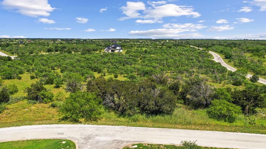 The Cliffs Resort Community on Possum Kingdom lake is a a paradise for those seeking a blend of leisure and luxury.  With amenities ranging from golf and dining to multiple swimming pools and a marina, there's something for everyone. Plus, the added security of a gated and guarded entrance provides peace of mind. Being steps away from the private pool is a delightful perk for this lot.