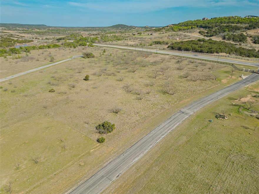 This 1.11-acre vacant lot is located in The Hills Above Possum Kingdom Lake, a gated community on the northeast side of the lake in Graford, Texas. This level lot offers tranquil lake views and is ideal for building a custom home.
The community provides upscale amenities, including an infinity-edge clubhouse swimming pool, a fitness center with state-of-the-art equipment, a boat dock, and a convenient watercraft launch. Possum Kingdom Lake itself is renowned for its crystal-clear waters, excellent boating opportunities, and top-tier fishing, making it a haven for outdoor enthusiasts.
The property is conveniently located about 20 minutes from Graham, a charming town with dining, shopping, and essential services. For those seeking a larger city, Fort Worth is approximately a 90-minute drive away, offering access to major airports, entertainment, and cultural attractions.