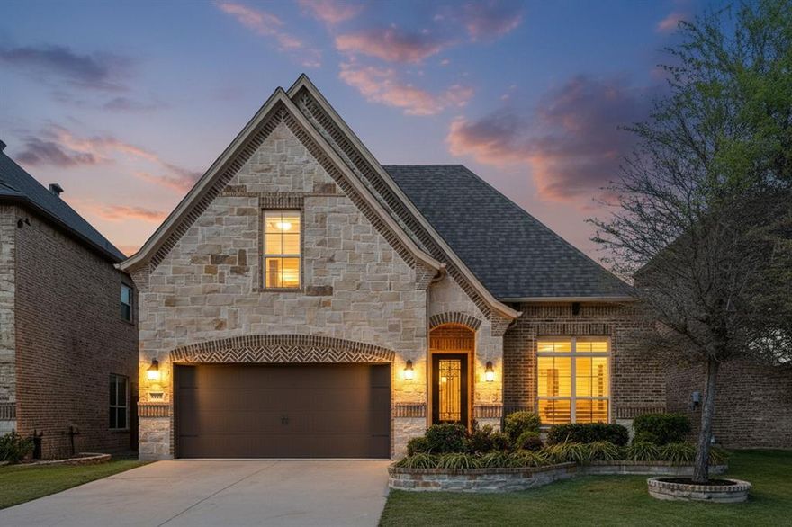 Welcome to 1864 Halifax Street in Roanoke, Texas, located within a private gated community in the highly sought-after Northwest ISD. This beautifully maintained home offers the perfect blend of luxury, functionality, and location, featuring 4 bedrooms, 3 bathrooms, and over 2,600 square feet of thoughtfully designed living space. From the moment you step inside, you’ll notice elevated architectural details including tray ceilings, crown moulding, and plantation shutters throughout that add timeless charm. The open-concept kitchen is a true focal point, offering abundant cabinetry, expansive countertop space, and seamless flow into the main living area. It's perfect for entertaining or everyday living. The living room features built-in surround sound, with additional audio extending to the media room and outdoor patio. A central vacuum system and reverse osmosis water system provide convenience and efficiency, while the radiant barrier helps keep utility costs reasonable year-round. Step outside to a private backyard retreat designed for relaxation and hosting, complete with an extended travertine patio, built-in fire pit, and outdoor kitchen. With no rear neighbors and mature trees, this space offers exceptional privacy. The upstairs layout is ideal for guests or multi-generational living, featuring a media and game room with wet bar, along with a private bedroom and full bathroom. The roof was replaced in 2025. Located just minutes from DFW International Airport, Southlake Town Square, Alliance Town Center, and downtown Roanoke - known as the “Unique Dining Capital of Texas”. This home offers unmatched convenience. Homes in this gated neighborhood do not stay on the market long, so schedule your private showing today before this opportunity is gone!