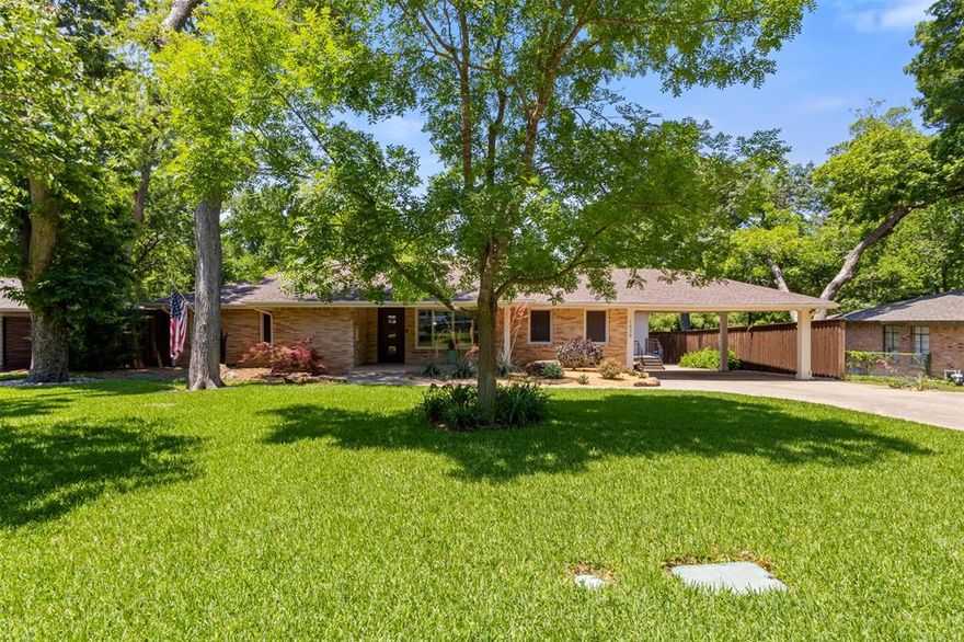 Every now and then a truly exceptional property comes on the market in East Dallas, and 1035 Waterford Dr. is one of those properties! This c. 1953 classically designed ranch home has been meticulously renovated with every detail addressed and executed with intention and love. Upon entry you can feel the thought and care that has been given by its current owners. The home features 3 Bedrooms, 2.5 Baths, 2 Living Areas, and wonderful guest quarters. The setting is remarkable, sited on a .4-acre lot and backing to a natural lush greenbelt. Beautiful oak hardwood floors throughout the home gives a rich warm feeling of comfort and stability. Formal Living and Dining room with large picture windows flows beautifully to the spacious Den with gorgeous views of the greenbelt. A true Chef's Kitchen features a 36-inch Thermador gas range, built in ice maker and wine fridge, stainless Frigidaire refrigerator, and a versatile island-bar, perfect for entertaining. Lovely primary suite with gorgeous spa like bath and custom walk-in closet. Other bedrooms are very generous in size and have wonderful windows and closets. Well-appointed quarters with its own private entrance with full bathroom, kitchenette and great storage make for a perfect multi-generational living lifestyle. Other updates include surround sound and outdoor speakers, solar screens, security cameras, new gas line and much much more. Walk to White Rock Lake as well as some of East Dallas' most trendy restaurants and coffee shops.  Located in exemplary Hexter Elementary School zone. Total square footage of 3152 includes the 562 square foot guest quarters.