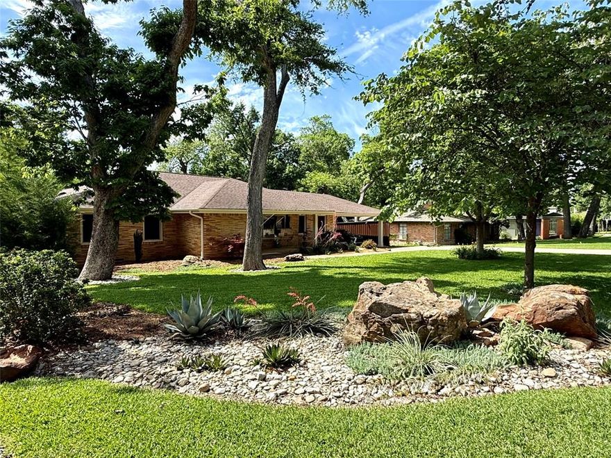 Every now and then a truly exceptional property comes on the market in East Dallas, and 1035 Waterford Dr. is one of those properties! This c. 1953 classically designed ranch home has been meticulously renovated with every detail addressed and executed with intention and love. Upon entry you can feel the thought and care that has been given by its current owners. The home features 4 Bedrooms, 3.5 Baths, 2 Living Areas, which includes the wonderful guest quarters. The setting is remarkable, sited on a .4-acre lot and backing to a natural lush greenbelt. Beautiful oak hardwood floors throughout the home gives a rich warm feeling of comfort and stability. Formal Living and Dining room with large picture windows flows beautifully to the spacious Den with gorgeous views of the greenbelt. A true Chef's Kitchen features a 36-inch Thermador gas range, built in ice maker and wine fridge, stainless Frigidaire refrigerator, and a versatile island-bar, perfect for entertaining. Lovely primary suite with gorgeous spa like bath and custom walk-in closet. Other bedrooms are very generous in size and have wonderful windows and closets. Well-appointed quarters with its own private entrance with full bathroom, kitchenette and great storage make for a perfect multi-generational living lifestyle. All appliances including the ones in the guest house, all tv's and mounts, and washer and dryer to remain with the property. Other updates include surround sound and outdoor speakers, solar screens, security cameras, new gas line and much much more. Walk to White Rock Lake as well as some of East Dallas' most trendy restaurants and coffee shops.  Located in exemplary Hexter Elementary School zone. Total square footage of 3152 includes the 562 square foot guest quarters.