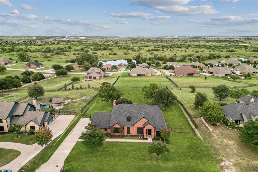 Perched on a hilltop in the gated community of Lago Vista at Bonds Ranch, this beautifully updated one-story home offers peaceful living with unbeatable access to modern conveniences. Just minutes from the brand-new Eagle Mountain High School and scenic Eagle Mountain Lake, this property combines serene surroundings with everyday ease. Set on a full acre, the home features a sparkling pool, an oversized covered patio perfect for entertaining, and sweeping views of the surrounding area. Inside, the open-concept layout is filled with natural light and anchored by a spacious living room with a cozy fireplace overlooking the backyard. The kitchen opens seamlessly to the living and dining areas and is equipped with granite countertops, an island with breakfast bar, walk-in pantry, and built-in microwave. The thoughtful split floor plan includes 4 bedrooms, 3 full bathrooms, and a 3-car garage with an oversized driveway large enough to park your boat. The private primary suite boasts a large walk-in closet, dual vanities, soaking tub, and separate shower. A secondary bedroom offers an en suite bath—ideal for guests or multigenerational living—while the remaining two bedrooms share another full bathroom. Recent upgrades (May 2025) include new interior and exterior paint, updated lighting and plumbing fixtures, a new roof, refreshed landscaping, improved fencing, and a deeper-set waterline. Enjoy the best of both worlds: tranquil living just 5 minutes from the lake, 25 minutes to downtown Fort Worth, 35 minutes to DFW Airport, and only 10 miles from the shopping, dining, and entertainment options at Alliance Town Center—including Costco and more. Community amenities include gated access, fishing ponds, playgrounds, swimming pools, and walking trails. Don’t miss your chance to enjoy the quiet of the countryside without sacrificing city convenience.