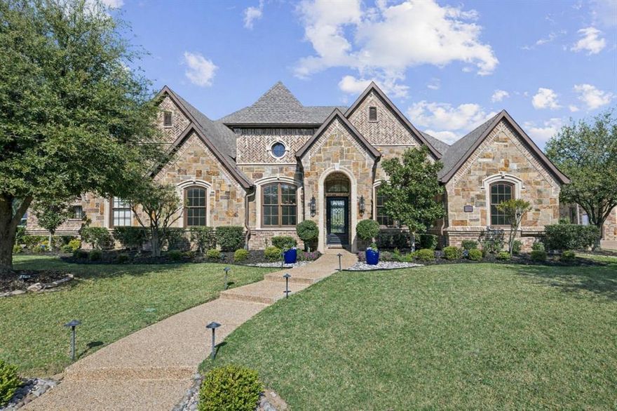 Welcome to an exceptional one-story estate in the prestigious Hills of Kingwood, originally crafted as the model home by Our Country Homes, showcasing the builder’s finest design, upgrades, & architectural craftsmanship throughout. From the moment you enter, you’ll notice the stunning millwork & thoughtful architectural details that set this home apart. The open-concept floorplan is both elegant & functional, centered around a spacious living room with a stone fireplace & expansive backyard views. Electric shades on the windows add convenience & comfort, while natural light fills the space. The living area seamlessly flows into a chef’s dream kitchen, featuring two oversized islands, a farmhouse sink, & premium Thermador appliances, including a built-in refrigerator, gas range, oven, & microwave, plus a pot filler. The kitchen is complemented by a bright breakfast area, a formal dining room, & a built-in wine bar, perfect for entertaining. The private primary suite offers a true retreat with space for a sitting area. The spa-like bathroom includes a soaking tub, walk-in shower with a rain head, & a linen closet for added storage. Three additional bedrooms are thoughtfully split from the primary suite, providing privacy for family or guests. Designed for both relaxation & entertainment, the home features a game room with a bar that includes a sink, microwave, & fridge that flows into a dedicated media room, ideal for movie nights or hosting gatherings. A richly appointed office with wood paneling, built-ins, & French doors creates the perfect work-from-home environment. Situated on nearly half an acre, the outdoor space is just as impressive. Enjoy the extended travertine patio complete with a fireplace, covered seating area with ceiling fan, & plenty of room to relax or entertain. A charming vegetable garden offers a wonderful opportunity for the next owner to cultivate and personalize, plus an EV charging station in the garage and access to scenic walking trails.