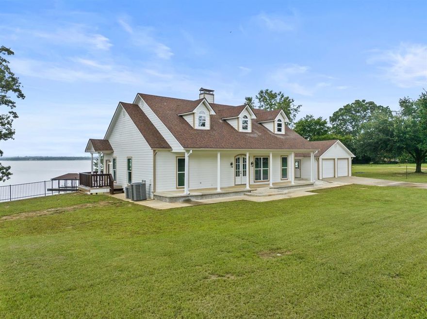 Discover the ultimate lakeside retreat at this stunning property nestled on the shores of Lake Bob Sandlin in the exclusiveParadise Village subdivision. Boasting luxurious updates throughout, this expansive home offers over 3,000 square feet of living space with multiple living and dining areas, making it ideal for hosting gatherings with loved ones while soaking in the serene lake views. Every corner of the house showcases breathtaking views and is bathed in natural light, creating a warm and inviting atmosphere. The primary suite beckons as a tranquil sanctuary featuring new carpet, a see-through fireplace, spa-like ensuite bath, and unparalleled views. Two cozy guest rooms share a well-appointed hall bath on the lower level, along with a spacious second living area. Additionally, a private guest suite with garage parking and ensuite bath provides a comfortable retreat for visitors. Dual covered porches offer the perfect spot to unwind and watch the sun dip below the horizon over the glistening lake, while a private boat house beckons for a day of water adventures. This lakeside oasis is where luxury living meets natural beauty! Call today to schedule your private showing.