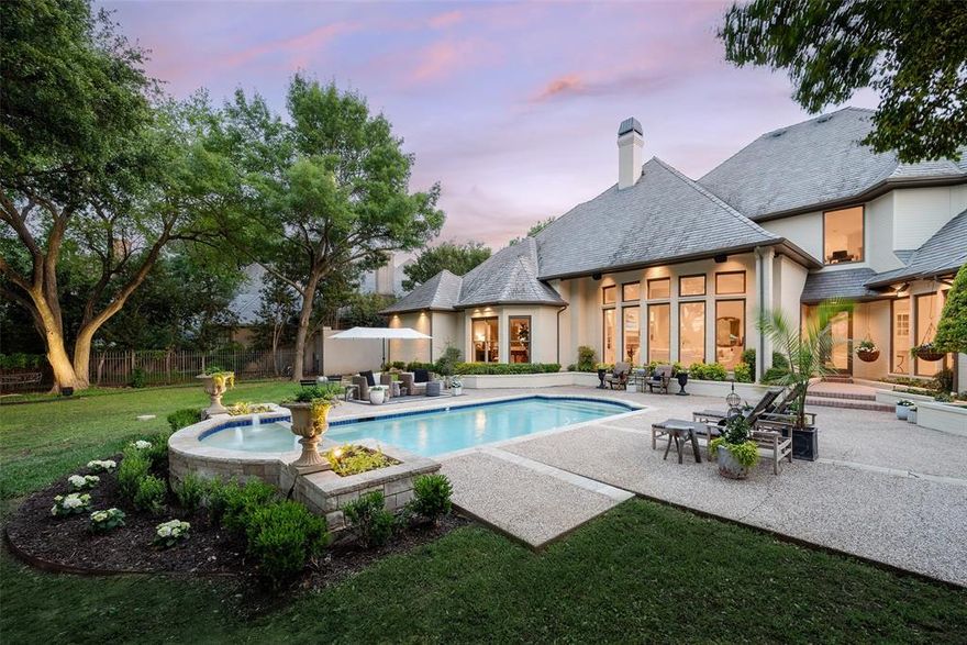 Nestled within the prestigious gated community of Los Arboles, 2 Manzano Circle is a thoughtfully updated estate set on a .62-AC cul-de-sac lot in the heart of Preston Hollow. Located inside this exclusive 24-hr guarded enclave, the home seamlessly blends timeless architecture, sophisticated design, + exceptional privacy. A refined exterior framed by manicured grounds, custom cast stone accents, + classic gas lanterns creates a memorable arrival experience. Inside, the home has been carefully enhanced with elevated finishes + purposeful design thru-out. Rich HW flooring, designer lighting + a newly installed gas range paired with a custom vent hood bring warmth + functionality to the main living spaces. The 1st-floor primary suite serves as a true sanctuary, generously sized + filled w natural light from expansive windows overlooking the lush backyard. The spa-like bath features a steam shower, freestanding soaking tub, dual vanities, a dedicated makeup vanity, + spacious walk-in and cedar closets. A secondary BR on the main level offers remarkable flexibility w custom built-ins, 2 walk-in closets + an updated en suite bath, making it ideal for guests, a private office, or additional living space. Upstairs, 2 oversized BRs each include beautifully renovated en suite baths, while a central landing area provides the perfect setting for a game room, lounge, or study space. An unfinished bonus room presents the opportunity to further tailor the home to your needs, while abundant storage can be found thru-out. Los Arboles, meaning The Trees was originally part of the historic Murchison estate + remains one of Dallas’ most serene + picturesque communities. Mature trees, tranquil ponds + elegant fountains create a peaceful, park-like environment just moments from premier private schools, luxury shopping + fine dining. Combining location, security + timeless refinement, 2 Manzano offers an exceptional opportunity in one of Preston Hollow’s most coveted neighborhoods.