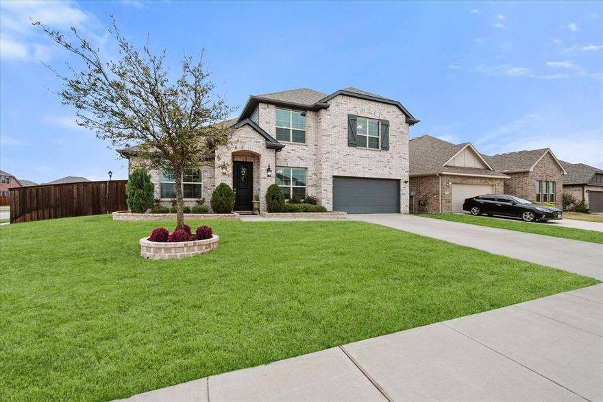 Situated on a desirable corner lot in the welcoming Wellington community, this beautifully designed home offers over 3,000 sq. ft. of thoughtfully crafted living space—perfect for both everyday living and entertaining. Located within the award-winning Northwest ISD, this 4-bedroom, 3-bath residence blends style, comfort, and functionality. Step inside to find luxury vinyl plank flooring throughout the main living areas, complemented by plush carpeting in the bedrooms and game room. The open-concept layout features a spacious living room anchored by a sleek gas fireplace, seamlessly connecting to the chef’s kitchen. Enjoy a large quartz island, 5-burner gas cooktop, stainless steel appliances, abundant cabinetry, and a walk-in pantry, ideal for both cooking and gathering. A separate dining room offers flexible use as a home office or formal space. The private primary suite features an oversized shower with a built-in bench, a spacious en-suite bath, and a large walk-in closet. A secondary bedroom and full bath are conveniently located on the main level for guests. Upstairs, a versatile game room provides the perfect second living area, along with two additional bedrooms, walk-in closets, and a full bath with easy attic access. The backyard is designed for relaxation and entertaining, featuring a covered patio extended by an open patio, perfect for outdoor dining and gatherings. The pool-sized yard is fully enclosed with a board-on-board privacy fence.
Recent updates include new lighting, first-floor carpet, LG stainless steel 5-burner range, window treatments, and more (see MLS for full upgrade list). Enjoy resort-style community amenities just a short walk away, including a pool, clubhouse, playgrounds, scenic ponds, and walking trails. Plus, this home includes a remaining builder’s warranty. Schedule your private showing today!