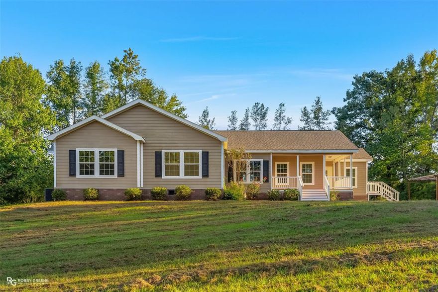 Step into the perfect blend of modern comfort and country tranquility in this beautifully updated 4-bedroom, 2-bathroom 2,600 square foot home set on a spacious 2-acre lot in Benton. Every detail has been carefully refreshed, featuring new paint throughout and plush new carpet in all bedrooms, creating a clean and inviting atmosphere from the moment you walk in. Inside, the open-concept living area offers a stunning sense of space and flow. The living room features a gorgeous stone fireplace as its centerpiece, framed by large windows that fill the home with natural light. Exposed wooden beams and soft recessed lighting enhance the warm, elegant tone of the interior while the neutral color palette makes decorating effortless. The kitchen is truly a chef's dream equipped with stainless steel appliances, white shaker cabinetry, a farmhouse sink, and a massive island with beautiful stone-look countertops that provides plenty of prep and gathering space. The primary suite provides a peaceful retreat with brand-new carpet, generous dimensions, and a luxurious ensuite bath featuring a soaking tub, dual vanities, and a separate tiled shower. Each additional bedroom is spacious, comfortable, and filled with natural light, perfect for guests, family, or a home office with walk in closets. Outside, the home’s inviting front porch and back pergola patio are ideal for relaxing evenings or morning coffee while overlooking the serene two-acre landscape. The property also includes a storage shed and plenty of open yard space for gardening or recreation. With its modern finishes, open layout, and peaceful setting, this home delivers the comfort, style, and space you’ve been searching for in one exceptional package. Call today to schedule your private showing!
