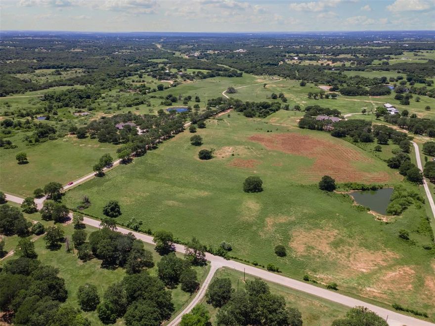 For sale is a stunning 109-acre property in Weatherford, TX, offering a perfect blend of natural beauty and practical functionality, just 15 minutes from the charming Downtown Weatherford and with quick access to I-20 for effortless connectivity. This expansive parcel boasts approximately 885 feet of road frontage, ensuring easy access and excellent visibility. The land features areas with coastal grass, ideal for cattle grazing, making it a prime choice for ranchers or those seeking agricultural opportunities. Three serene ponds dot the landscape, providing water sources for livestock and enhancing the property’s tranquil ambiance. A seasonal creek meanders through the acreage, adding to its scenic allure, while great mature oak trees offer shade and timeless beauty. For outdoor enthusiasts, this property is a hunter’s paradise, with abundant deer and other wildlife, making it an exceptional spot for hunting or simply enjoying nature. Whether you’re looking to establish a working ranch, build a dream home, or invest in a versatile piece of land, this 109-acre gem in Weatherford combines rural serenity with convenient proximity to urban amenities, offering endless possibilities for your vision.