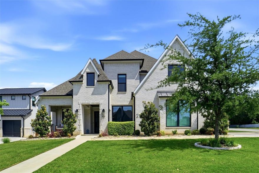 A rare modern retreat in North Keller, this 2020-built home offers resort-style living for under $2M just minutes from Westlake and Southlake. Filled with natural light, soaring ceilings, and designed for effortless indoor-outdoor living, the home blends clean architectural lines with refined, inviting spaces created for both entertaining and everyday luxury. Expansive glass and open sightlines create a seamless connection to the resort-style outdoor setting beyond. The backyard was designed to feel like a private resort, featuring a custom pool with tanning ledge and oversized spa, a covered outdoor living area with built-in kitchen and BBQ, a wood-burning fireplace, and low-maintenance turf creating a lush setting for year-round enjoyment. Inside, the flexible floor plan includes five bedrooms, with a serene primary suite and private guest retreat on the main level ideal for multigenerational living or extended stays. Upstairs, additional bedrooms, a spacious game room, and a dedicated media room provide room to relax and unwind. Additional highlights include a wine cellar, electric window shades, built-in refrigerator, a 3-car garage, gated RV parking with extended side space, and no HOA.