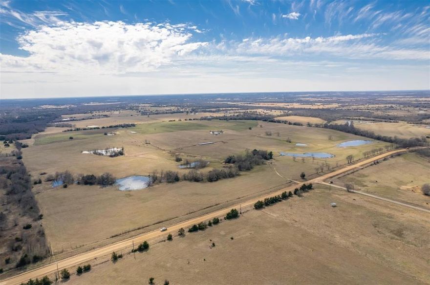 Beautiful rolling tract with scattered trees and multiple ponds. Improved pasture, totally fenced and cross fenced. Plenty of available co-op water and electricity. Long paved road frontage makes it easy to sub divide.