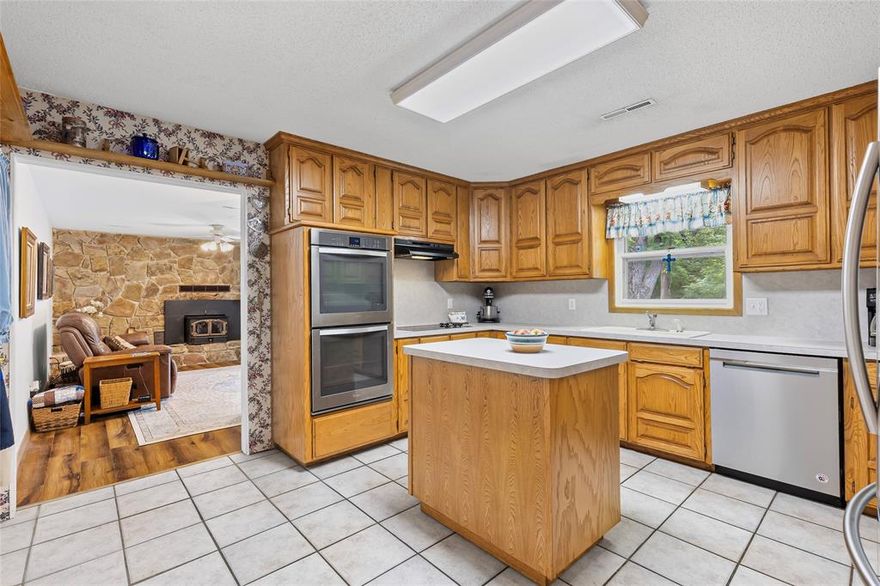 Behind all the seclusion & unmatched privacy, you will find a wonderful 6 ac, 3 bedroom, 2 bath, 2315 sf, a 2 car garage, garage door opener in the main house. Inside you will find a Formal Living RM or could be a wonderful office. Overall, you will see some new custom flooring & new paint. The Kitchen has wood-stained cabinets, great counter tops, walk in pantry, a mobile custom island, all electric appliances & a double oven for lots of baking.  The Den has a stove type wood burning fireplace & a sliding glass door to the patio. The guest bathroom has double sinks & new tile flooring. The Primary bathroom has new paint, walk in closet, separate shower, tub & a sink. The utility room has a sink, cabinets & a counter. A custom separate 30x40 metal building-shop with a 20’ deep covered carport. The inside has electrical to work with, insulation, concrete floor, LED lighting,1 roll up door & a walk in door. This property has a new 11’ x 20’ concrete patio, ½ acre garden w sandy loam soil w a 55 ft deep well to provide water. There is also an abundance of wildlife in this area, many deer, hog and small animals.  There is only a half of acre to be mowed on this secluded property. This property is 3.5 miles to McDonald's and 4 miles to Walmart. There are many restaurant's, church's & movie theaters in Bonham to enjoy.   Call me for an appointment to see this secluded place.