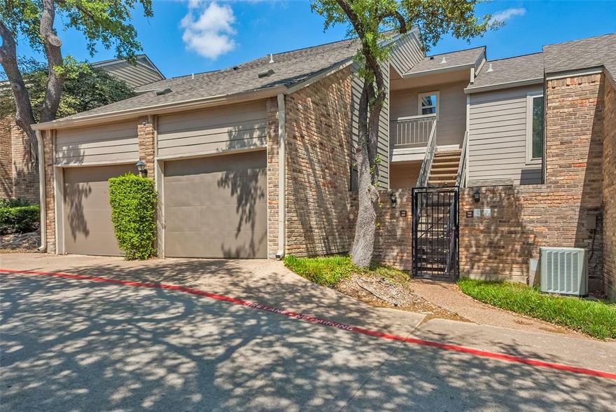 Located within the gated Oaks On Montfort community, this beautifully remodeled one-bedroom, one-bath condo offers a perfect blend of style, comfort, and convenience. With an open-concept layout, the home features brand new windows, fresh paint throughout, and updated luxury vinyl plank flooring in the main living areas.  The stunning kitchen features beautiful, warm wood cabinetry with granite countertops, and a sleek glass subway tile backsplash.   The light-filled living room showcases vaulted ceilings, skylights, and a cozy, wood-burning fireplace, creating an inviting atmosphere. Step out onto the private balcony to enjoy the home’s unique treehouse feel.  The spacious bedroom offers brand new carpet and a generous reach-in closet.  The bathroom has also been completely updated with a large vanity that offers plenty of storage and stylish tile throughout.  An attached one-car garage with extra storage adds to the functionality, while residents enjoy access to two community pools within this secure, gated setting. Ideally located just minutes from Galleria Dallas and the vibrant dining and entertainment scene in Addison, this home offers low-maintenance living in a prime North Dallas location!