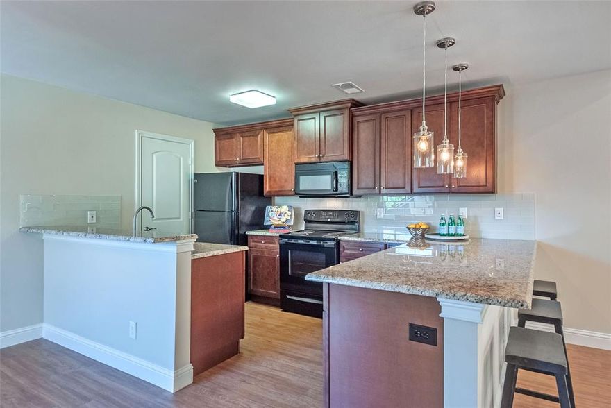 RARE FIND! Located within the gated Oaks On Montfort community, this completely redone, beautifully remodeled, one-of-a-kind condo offers a perfect blend of style, comfort, and convenience. With an open-concept layout, the home features brand new windows, fresh paint throughout, and updated luxury vinyl plank flooring in the main living areas.  The stunning kitchen features beautiful, warm wood cabinetry with granite countertops, and a sleek glass subway tile backsplash.   The light-filled living room showcases vaulted ceilings, skylights, and a cozy, wood-burning fireplace, creating an inviting atmosphere. The spacious bedroom offers brand new carpet and a generous reach-in closet.  The bathroom has also been completely updated with a large vanity that offers plenty of storage and stylish tile throughout.  An attached one-car garage with extra storage adds to the functionality, while residents enjoy access to two community pools within this secure, gated setting. HVAC was replaced in 2021 and water heater was replaced in 2022  for additional peace of mind. Ideally located just minutes from Galleria Dallas and the vibrant dining and entertainment scene in Addison, this home offers low-maintenance living in a prime North Dallas location!