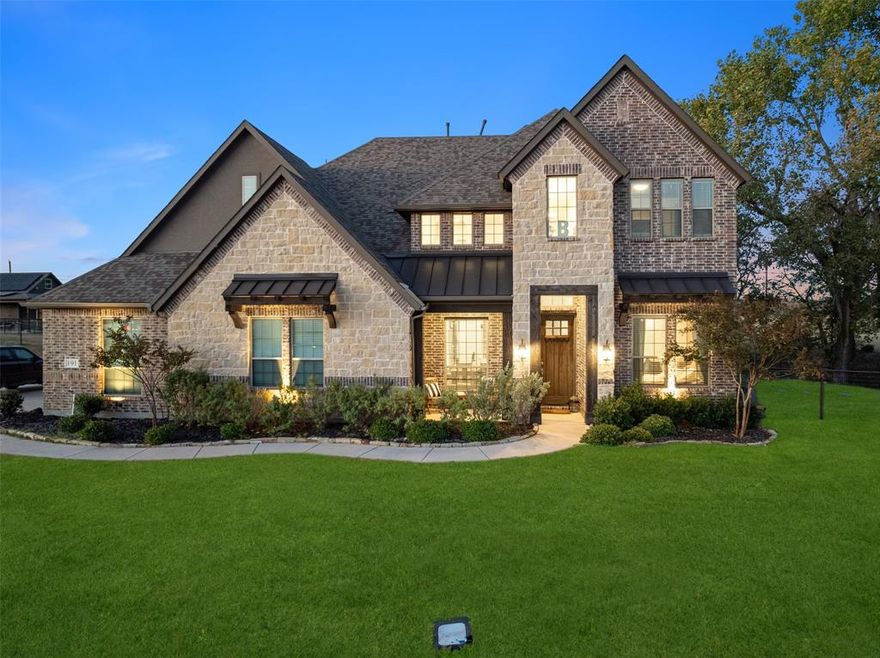 Discover this magnificent 4,000+ SQFT home with premium upgrades in Chapel Creek Farms in Van Alstyne.  Enjoy scenic country living where luxury meets country charm!  Situated on over an acre with breathtaking views, this home boasts exquisite craftsmanship and top-tier upgrades throughout. The striking stone and brick exterior, accented with stylish metal roofing, creates an unforgettable first impression. Inside, no detail has been overlooked. The thoughtfully designed kitchen is a chef’s dream, featuring stainless steel appliances, a spacious work island with seating, double ovens, a gas cooktop, and elegant arched openings that flow seamlessly into the living area—ideal for entertaining. Under-cabinet lighting enhances both function and ambiance, while solid wood doors throughout the home showcase superior quality. The open-concept living space is warm and inviting, perfect for hosting gatherings or enjoying quiet evenings at home. The primary suite serves as a private retreat with a cozy sitting area overlooking serene country views. Pamper yourself in the spa-like bathroom with a luxurious corner tub, dual vanities, and a walk-in shower. Entertainment options abound, with a game room for friendly competition and an adjacent media room ready for your favorite flicks. Additional upgrades include beautiful iron balusters, a covered porch for outdoor relaxation, and a built-in gas hookup for grilling. Beyond the home, the expansive lot offers even more possibilities. The extended driveway provides ample space to add a workshop, metal building, or detached garage—perfect for extra storage, a personal workshop, or even a home business setup. Conveniently located just 14 minutes from Texas Instruments in Sherman, TX, this exceptional home offers all the bells and whistles, ensuring both luxury and functionality in a peaceful country setting. Don't miss this rare opportunity to own a beautifully upgraded home in a prime location! Pictures 28,30 are AI generated.