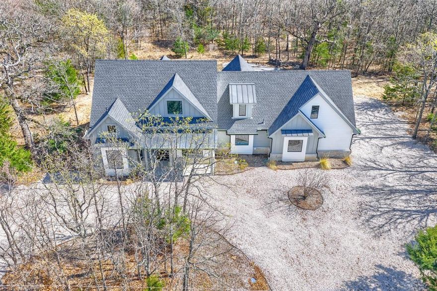 SELLER WILLING TO CONTRIBUTE UP TO $15K IN BUYER'S RATE BUY DOWN OR CLOSING COST ASSISTANCE WITH ACCEPTABLE OFFER! Motivated Seller!  Step into a newly built, magazine-worthy Custom Retreat where thoughtful engineering meets elevated style with Richland-Chambers Lake across the street. Welcome to a modern country smart home that pairs head-turning style with rock-solid engineering. A gorgeous pivot steel door swings open to welcome you onto white-oak wood floors and sight-line picture windows, while spray-foam insulation, 45 twelve-inch concrete piers, and underground drainage quietly protect the structure.  All is backed by a ten-year builder warranty and two-year septic guarantee. The chef’s kitchen centers on a marble island wrapped in color-changing LEDs, a 36-inch dual-fuel range with six burners, convection microwave, Café tub dishwasher, quartz perimeter tops, and a hidden pantry finished in quartz counters inside. Those LEDs echo around the living-room TV above an electric fireplace set into a porcelain accent wall.  A two-stage high-efficiency HVAC keeps the climate weather perfect. Upstairs, a blackout-ready great room hosts a 55-inch screen and a built-in quartz bench; every room is wired with coax, and cat-6 with Ethernet upstairs in office game room.  The outdoor living with kitchen and a 55-inch patio TV, sound-bar, subwoofer, dimmable can lights, and a fire-pit invite star-lit gatherings. A manifold system offers instant whole-house water shut-off, a tankless heater provides endless hot water, and Wi-Fi cameras watch the perimeter. Fridge, and wine cooler are ready for your use. Just move on in and enjoy your dream home and write your next chapter.