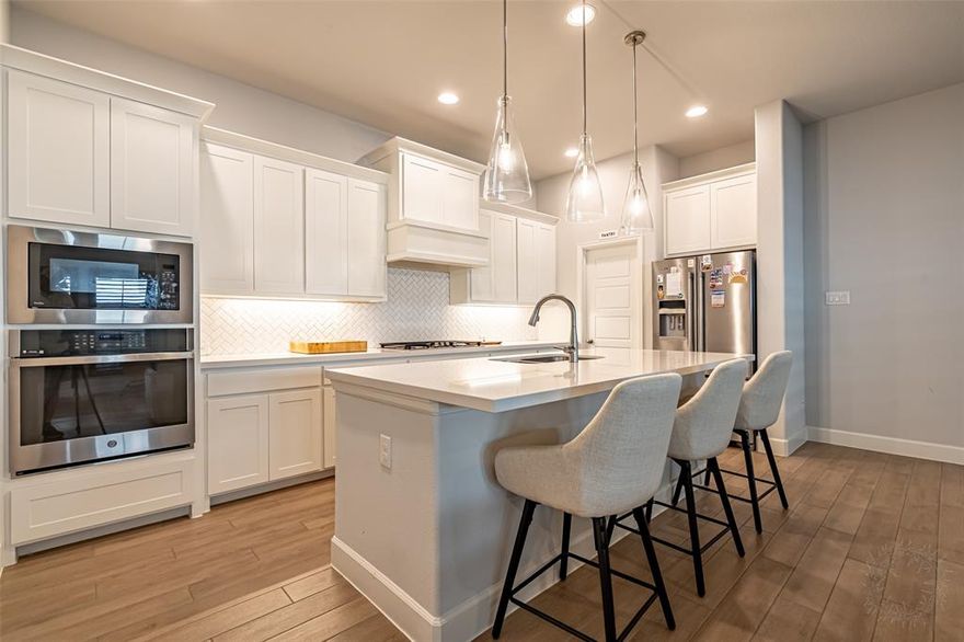 Enjoy resort-style living in this premier master-planned community, with HOA amenities including tennis courts, dog parks, a state-of-the-art multi-use gym designed for dynamic free-movement workouts, a kids' pool, adult lap pool, an updated neighborhood market with healthy snacks and local treats, and a fully equipped makerspace for building and creating with expert-grade tools. This nearly brand-new townhome is filled with natural light, soaring ceilings, and elegant finishes throughout, including 8-foot doors, 6-inch baseboards, and plantation shutters. The chef-inspired kitchen features top-of-the-line appliances, quartz countertops, gas cooktop, oversized island, built-in wall oven and microwave, and a walk-in pantry. A split bedroom layout offers three bedrooms and two full baths, with open-concept living and dining spaces perfect for everyday living and entertaining - all nestled in the heart of the highly sought-after Walsh Ranch community.