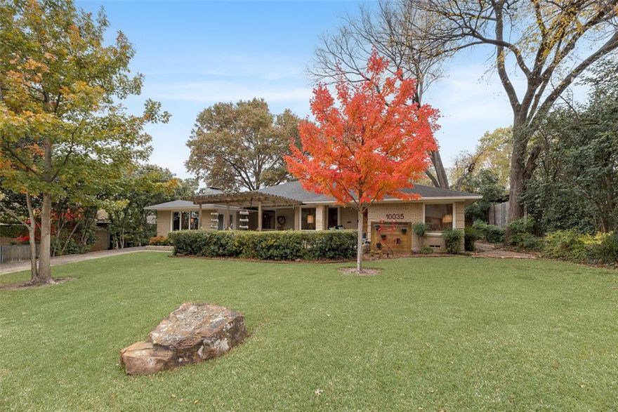 Old Lake Highlands Classic Awaits! Thoughtfully updated throughout and perfectly designed for gracious entertaining, you will feel right at home at 10035 Woodgrove Drive.  Enjoy views of the manicured front lawn and picturesque street beyond through oversized picture windows in your flexible dining or living spaces or from the comfort of your front terrace covered by a charming arbor.   The sunken main living area boasts hardwoods, a perfect mid-century fireplace and built-ins galore.   The kitchen is nicely updated with stainless appliances, marble counters, hardwoods and abundant storage.  The primary offers a luxe en-suite bath and large walk-in closet.  Additional bedrooms are nicely sized and serviced by a beautifully appointed full bath.   The backyard is a dream with multiple seating areas, flagstone, large covered deck, top quality turf throughout and beautiful wood fence.   The perfect space for large scale entertaining or more intimate affairs.  Delightfully hip out buildings add storage space or potential for workshop or office space.   A large 2 car garage is in the back with parking pad for additional vehicles or your golf cart for visiting all your friendly neighbors.   All this and only moments away from White Rock Lake, Norbuck Park and Flag Pole Hill.  Hexter Elementary! Come visit this gem and then start packing!