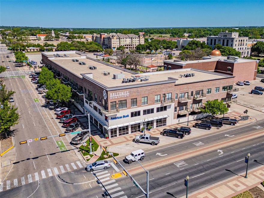 Live above it all at The Balconies in the heart of Downtown Waco. This stylish corner unit pairs an open, airy floor plan with custom built-ins, a chic dry bar, and designer updates throughout. Walls of windows frame sweeping views over Franklin Avenue—catch sunrises, spot Baylor and the Silos, and enjoy front-row seats to the Baylor Homecoming parade right from your private balcony. The secured building offers multiple staircases and an elevator for easy, lock-and-leave convenience. Moments to coffee, dining, shops, live music, and the river—urban living at its best.