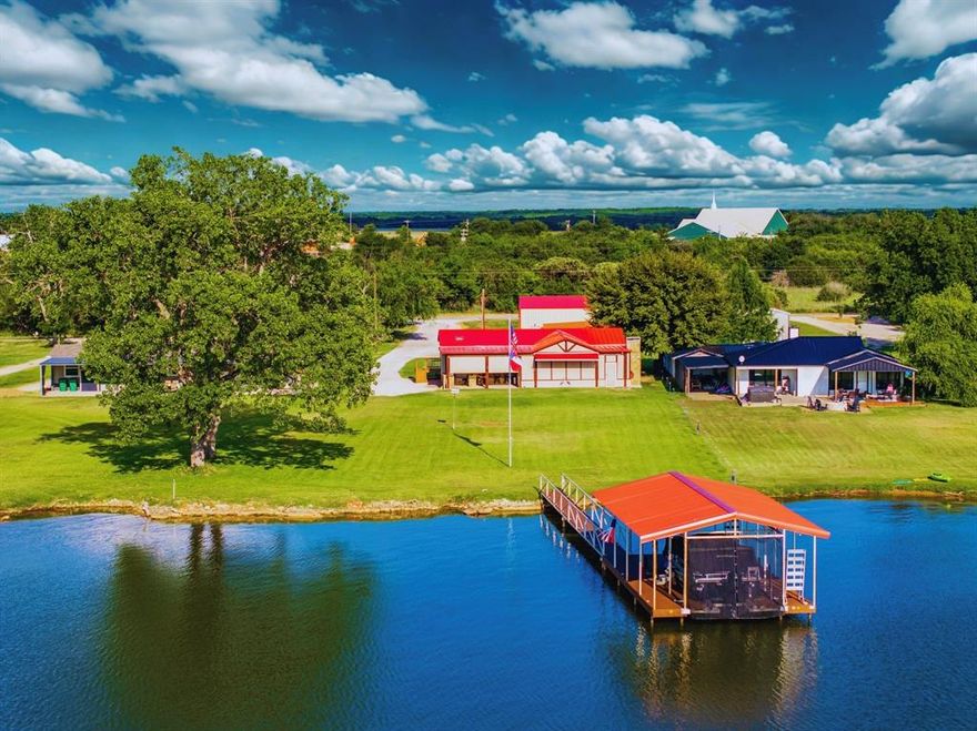 PRICE IMPROVEMENT on this BEAUTIFUL, LEVEL 1.13AC WATERFRONT 3BD, 2BA LAKEHOME with 1BD, 1HALF BA GUESTHOUSE, OUTDOOR ENCLOSED LIVING AND DINING PATIO, COVERED OUTDOOR KITCHEN, 4 CAR GARAGE, 2 SHOP BUILDINGS, AND DOCK, all on the Most Peaceful Area of POSSUM KINGDOM LAKE, with Panoramic LAKE VIEWS. The 1456 sqft Home is Light and Bright with Open Concept Living Design, and has Gorgeous Lake View Windows throughout the house. The Kitchen features All Black Stainless Steel Appliances, Quartz Countertops and Bar Seating. From the Living Room you can access the Large Enclosed Patio with Custom Rock Fireplace, Solar Shades, and plenty of Seating for watching games on the TV, and Dining Outside, all while watching the Breathtaking Lake Views, Spectacular PK Sunsets and Tx Starry Nights. Next to the Patio is the Covered Outdoor Kitchen and Grill, with Bar area for Outdoor Entertaining as well. The Single Slip Boat Dock with Platform Lift has easy level access from one of the two drop in staircases for swimming in the sandy bottom lake, and the Fishing is Fantastic. There are 2 Shops one 720 sqft built to accommodate an RV or Tower Boat, and one 1200 sqft that currently serves as a Workshop, both with Large Overhead Doors, and all with Security Cameras. Then there is a 4 Car 1200 sqft Garage with 2 Overhead Doors. All Overhead Doors have Garage Door Openers. Lastly, between the Garage and Main House, is the 424 sqft Guesthouse which Features 1 Large Open Room and Half Bath.This is the BEST of PK Lake Living, and Close to all the Amenities, Dining and Hiking Trails on the Peninsula at PK. New Standing Seam Metal Roof in 2025, New Septic in 2022, New Windows & Flooring in 2024. Chip Seal Driveway. No HOA and would make for a great VRBO Rental, or Build your Dream PK Lake Home on this Stunning Lot.