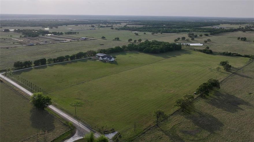 15.202 Acres of Prime Texas Pastureland – Fenced, Ready & Beautifully Improved! Discover peaceful country living on this stunning 15.202-acre tract of land, one of two tracts available. This picturesque property boasts lush, grassy pastureland, fully fenced for livestock, and features a pipe-fenced entrance that makes a striking first impression and a pond located in the back. A water meter is already installed, and electricity is readily available at the front, making this land ready for your dream home setup. Freshly planted cedar elm trees line the landscape, promising future shade and beauty as they mature. With a paved road leading right to the property, access is easy and convenient for commuting. Whether you're looking to build or simply escape to wide-open spaces, this tract offers an exceptional opportunity in a serene setting. Please note: Mobile homes are not permitted. Survey available.