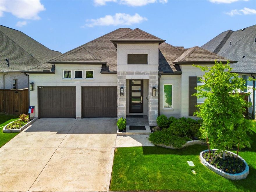 Exceptional Britton Homes single-story built in 2022, positioned on a premium lot backing to a large greenbelt with no rear neighbors, offering rare privacy in the award-winning lakeside community of The Tribute. Extensively upgraded with luxury finishes and integrated smart technology, this home is ideally suited for buyers seeking top-of-market quality. With over $130,000 invested in thoughtful, high-end upgrades, every detail has been carefully curated for both comfort and sophistication.

The open-concept layout showcases a stunning floor-to-ceiling marble fireplace that operates by remote, expansive living space, and a gourmet kitchen featuring GE Monogram appliances, ceiling-height glass tile backsplash, soft-close cabinetry, contemporary GE Cafe vent hood, and generous counter space ideal for entertaining. A versatile study with closet offers flexibility as an office, media room, or additional bedroom.

The private primary suite features dual vanities, freestanding tub, dual showers with rain head, and two spacious walk-in closets. This home is loaded with premium upgrades including high-end wood tile flooring throughout, quartz counters throughout, motorized UV blinds, whole-house Generac generator, solar system, network-enabled irrigation and lighting, pre-wired security and audio, premium TOTO wash lets, and advanced automation features.

The three-car garage includes epoxy floors, built-in cabinets, workbench, overhead storage, and 220V outlet. Professionally landscaped backyard features premium Italian motorized patio screens and serene greenbelt views.

Located in The Tribute, residents enjoy 36 holes of championship golf, tour-caliber practice facilities, a 33,000-square-foot Scottish-inspired clubhouse, resort-style pools, splash park, pickleball courts, kayak launch, and 10+ miles of trails along Lake Lewisville. A full-service marina with 800+ boat slips, lakeside park, sand volleyball, and event lawn is planned for 2026.