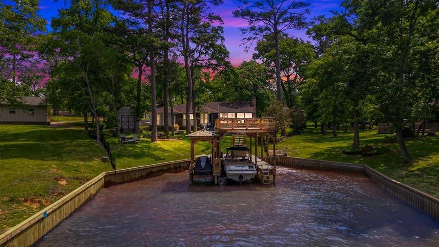 Discover your dream retreat situated along the stunning shores of Lake Palestine in East Texas. This exquisite waterfront home invites you to experience lake life like never before, offering breathtaking sunset views and a host of luxurious amenities. Boasting three spacious bedrooms plus a dedicated office, this residence is perfect for families or those seeking extra space for work and leisure. With 2 bathrooms and a 2 car garage, convenience and comfort are at the forefront of this charming home. Step outside to your fenced-in backyard, where you'll find a double-decker boathouse, perfect for soaking in those picturesque evenings by the water. The outdoor retreat is complemented by a brand-new Generac generator, ensuring peace of mind and uninterrupted relaxation during your lake stay. Inside, the home has been completely updated with stunning luxury vinyl plank flooring, marble kitchen countertops, fresh paint, and modern lighting that create an inviting atmosphere throughout. Enjoy year-round entertainment in the enclosed back patio, which can be heated and cooled, making it the ideal spot for morning coffee or sunset views over the lake. Additionally, the property features a converted outdoor building, currently serving as a man cave. This home can be purchased as a fully furnished turn-key retreat, allowing you to simply walk in, kick off your shoes, and start enjoying lake life right away. Alternatively, you have the option to customize the space to your liking, creating your own personal haven with your own furnishings. Nestled in a welcoming community where neighbors stroll and enjoy the serene surroundings, you'll find a private marina with boat and trailer storage available, as well as access to multiple parks. Don’t miss this incredible opportunity to own a slice of lake life paradise. This charming and exquisite home in Cumberland Ridge is ready to welcome you to East Texas living at its finest!