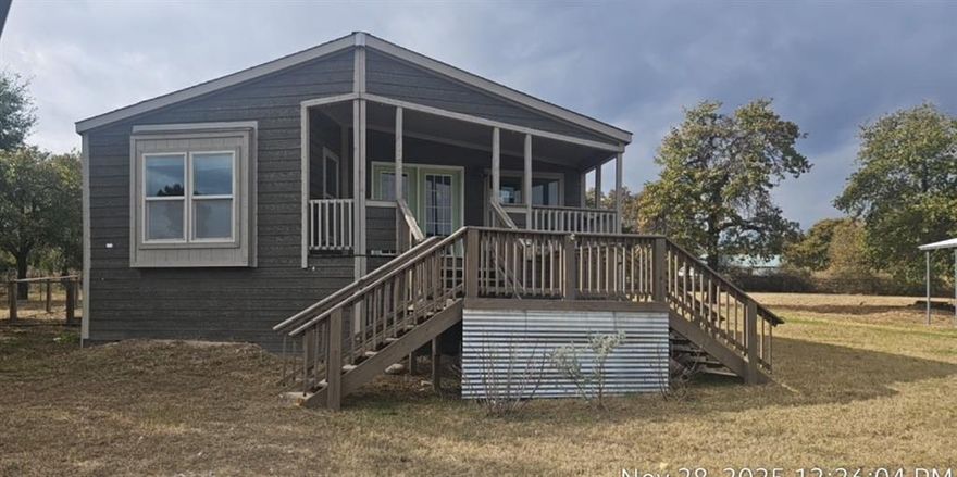 New home in your future? Check out this charming 3 bedroom 2 bath manufactured home on 1 acre with a few nice trees. Open living area has a stack stone fireplace and wall of windows. Plentiful cabinets,walk in pantry and desk space can be found in the spacious island kitchen. The adjoining dining room has beautiful special lighting. Laundry room, with outdoor access, is ready for full size washer, dryer and freezer. Primary bedroom with ensuite includes double vanities, garden tub, separate shower and walk in closet. Secondary bedrooms are a good size, Small fenced in yard off the side porch via the laundry room. The 1200 SF shop building with 400 SF carport provides great workspace, storage and covered parking. Come out and take a look!