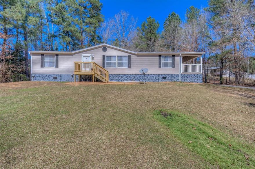 Looking for space, affordability, and lower property taxes? This one checks all the boxes! This well-maintained 3 bedroom, 2 bath doublewide offers 1,581 heated square feet of comfortable living space and sits on 1.28 acres, giving you room to spread out and enjoy country living. With a Minden address but located in Claiborne Parish, you’ll benefit from parish property taxes while still being convenient to town the best of both worlds! Built in 2007, this home features a functional floor plan with spacious bedrooms, a private primary suite, and plenty of living space for gathering with family and friends. Major updates include a roof replacement at the end of 2025, giving peace of mind to the new owner. Outside, you’ll love the large 2-car carport and the open acreage offering endless possibilities, garden, workshop, play area, or simply enjoy the extra elbow room. If you’ve been looking for affordable land, updated improvements, and a move-in ready home, this one deserves a look!