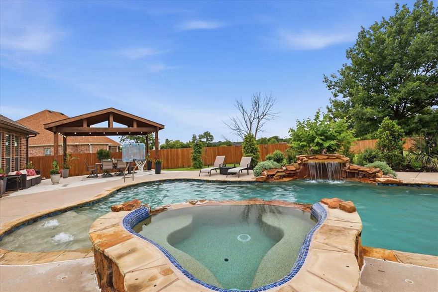 Looking for a 4-bed single family home with a pool, guest house, sunroom, gazebo, and exceptional garage space? This Fort Worth property offers 3,401 square feet, 4 full baths, a 0.647-acre lot, attached 3-car garage, additional oversized 2-car garage, and a 415-square-foot guest house.

Welcome to 1316 Durango Springs Drive in Fort Worth, a custom traditional home in the highly desirable Spring Ranch Addition within Northwest ISD. Set on a landscaped interior lot with mature trees, sprinkler system, wood and wrought iron fencing, and a spacious backyard, this property is built for flexible living, entertaining, storage, and everyday comfort. Inside, the open living area features vaulted ceilings, a stone fireplace, built-in cabinetry, wood floors, and large windows that bring in natural light and backyard views. The kitchen offers granite counters, breakfast bar, island, pantry, gas cooktop, built-in cabinetry, eat-in space, and a natural connection to the dining, living, and sunroom areas. The private primary suite includes a sitting area, dual sinks, garden tub, separate shower, separate vanities, linen storage, and walk-in closet. A split-bedroom layout adds privacy, while additional bedrooms include walk-in closets and flexible bath access. The home also includes a large utility room with built-ins, drip-dry area, freezer space, and full-size washer and dryer area. Outdoors, enjoy a resort-style pool with safety cover and spa, covered patio, garden areas, gazebo, several beautiful trees including fruit trees, Fire Pit, Horseshoe pit and a 415-square-foot guest house for flexible use. Vehicle, hobby, and storage needs are well served by the attached oversized 3-car garage plus an additional oversized 2-car garage with workshop potential, epoxy flooring, garage openers, RV or boat parking, and extra storage. This 4-bed single family home in Spring Ranch also offers community access to a park, playground, perimeter fencing, and HOA-managed facilities.